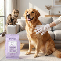 Wiping a golden retriever with a Swypy glove wipe while a cat watches